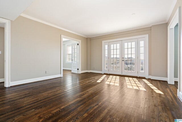 unfurnished room with crown molding, baseboards, dark wood-style flooring, and french doors