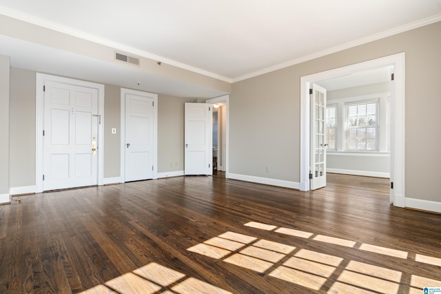 interior space with ornamental molding, visible vents, baseboards, and wood finished floors