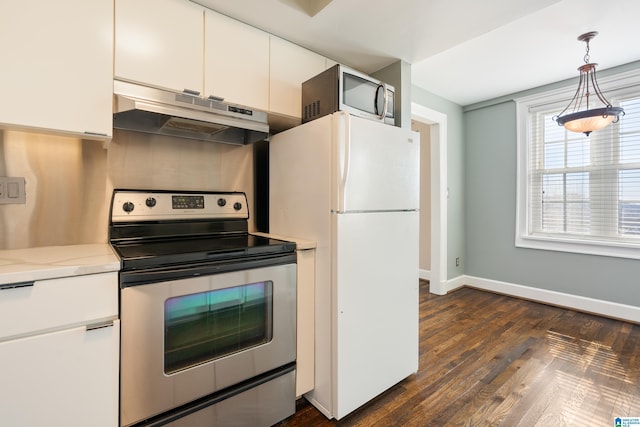 kitchen with under cabinet range hood, dark wood-type flooring, white cabinetry, baseboards, and appliances with stainless steel finishes