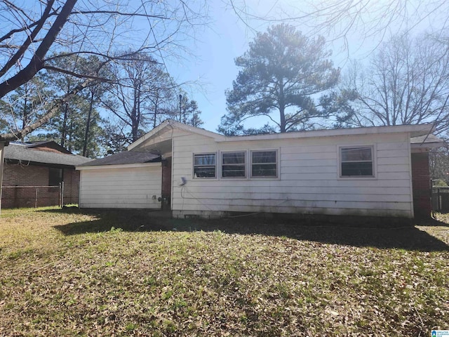 view of side of property with a yard and fence