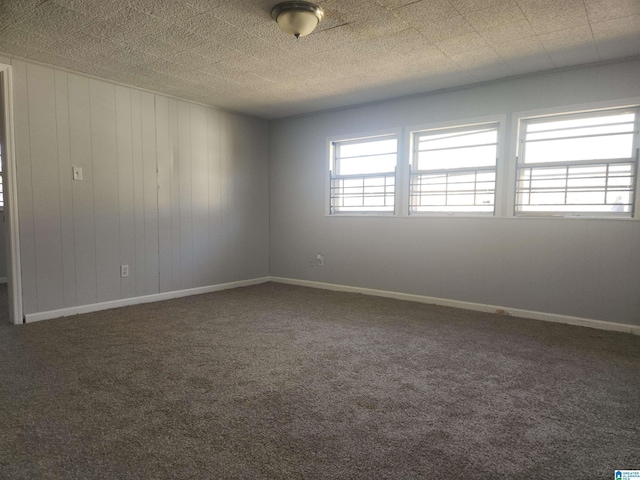 spare room with a healthy amount of sunlight, baseboards, and carpet floors