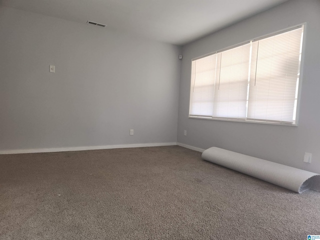 carpeted empty room with baseboards and visible vents