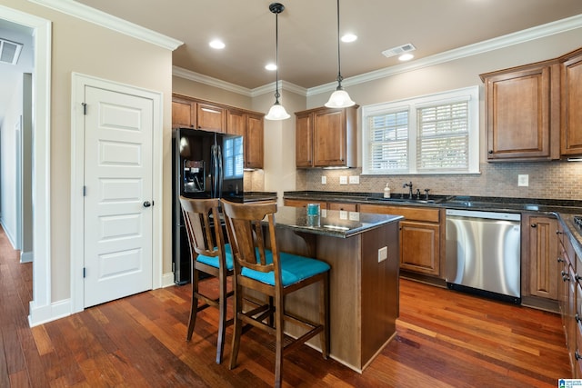 kitchen with dark wood-style floors, a breakfast bar, ornamental molding, a sink, and dishwasher