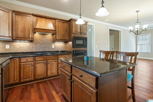 kitchen with dark wood-type flooring, black appliances, a breakfast bar, crown molding, and custom exhaust hood