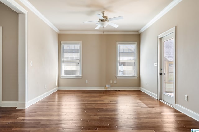 empty room featuring ceiling fan, baseboards, dark wood-style floors, and crown molding