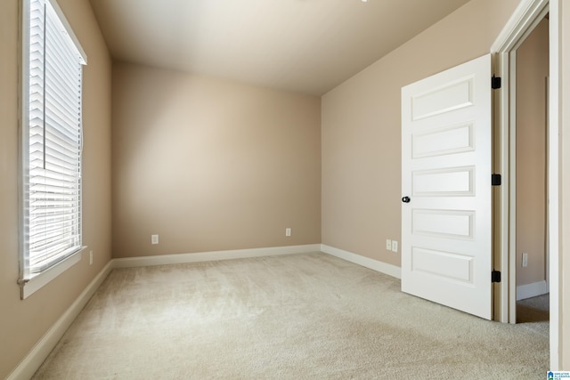 unfurnished room featuring baseboards and carpet floors