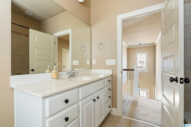 bathroom featuring tile patterned floors, ornamental molding, and vanity