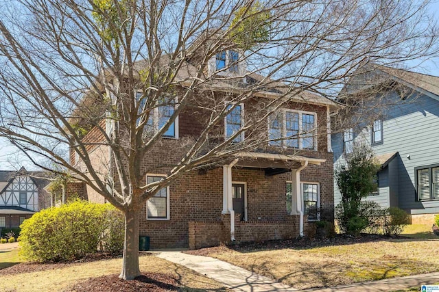 view of front of house with a front yard and brick siding