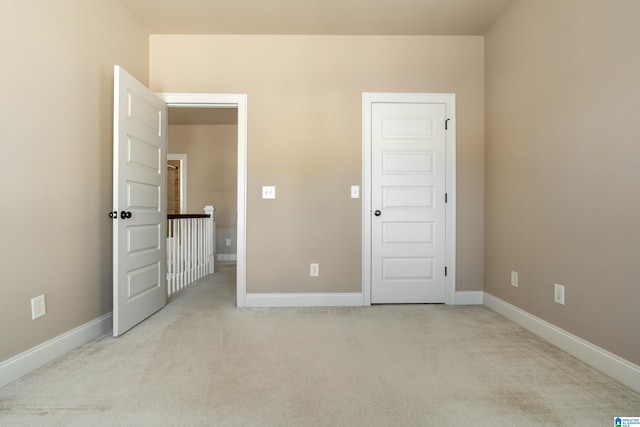 unfurnished bedroom featuring baseboards and carpet flooring