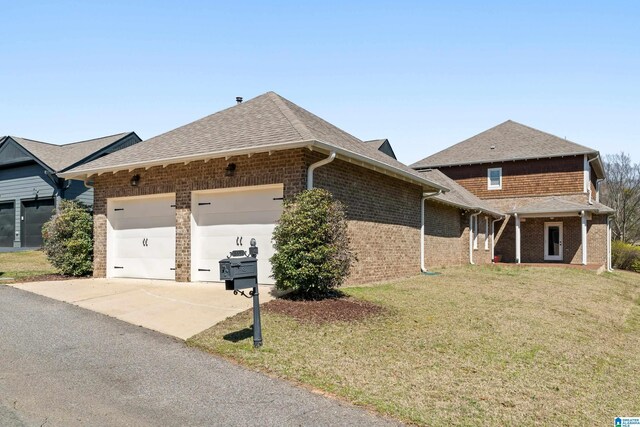 view of front of home featuring a garage, brick siding, concrete driveway, and a front yard