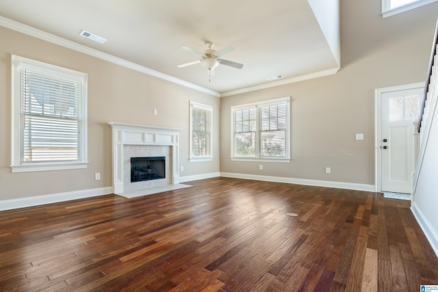 unfurnished living room with visible vents, dark wood-style floors, crown molding, baseboards, and ceiling fan