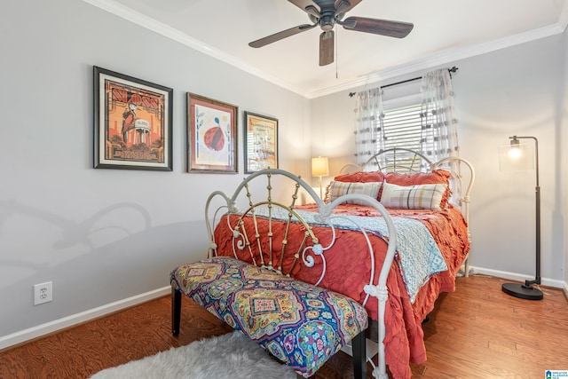 bedroom featuring baseboards, a ceiling fan, wood finished floors, and crown molding