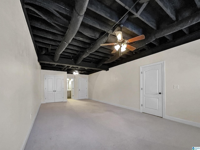 interior space featuring beamed ceiling, a ceiling fan, and baseboards