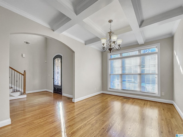 foyer entrance featuring stairway, visible vents, light wood finished floors, baseboards, and arched walkways