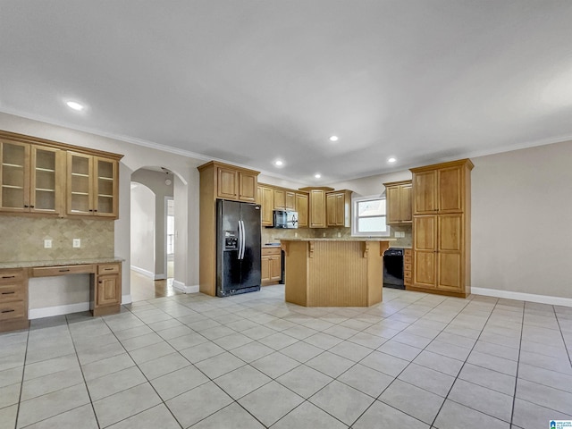 kitchen with decorative backsplash, a kitchen breakfast bar, light tile patterned flooring, arched walkways, and black fridge with ice dispenser