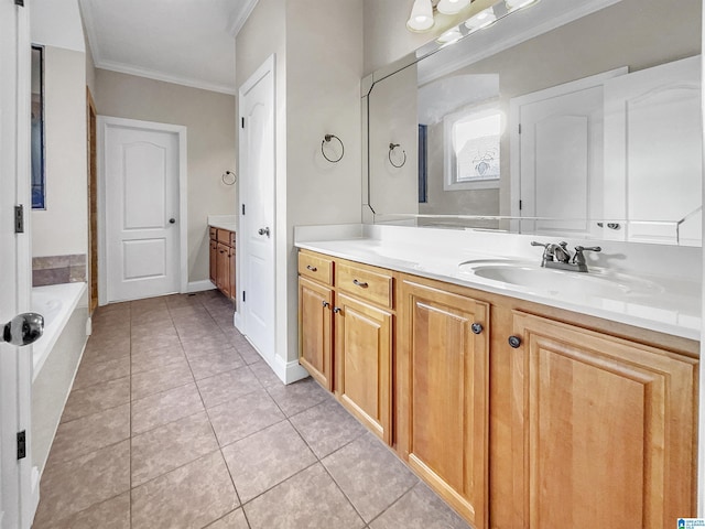 bathroom featuring ornamental molding, a bathing tub, tile patterned flooring, baseboards, and vanity