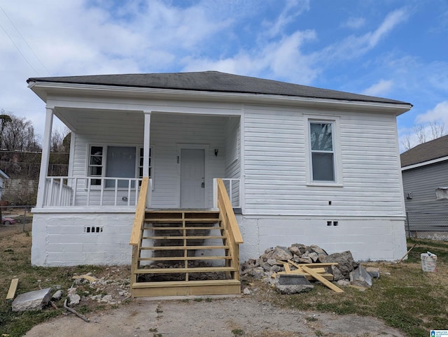 view of front of home featuring stairs, roof with shingles, a porch, and crawl space