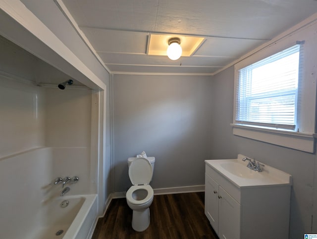 full bath featuring toilet, wood finished floors, vanity, baseboards, and shower / bathing tub combination