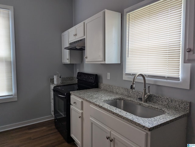 kitchen featuring under cabinet range hood, black range with electric stovetop, a sink, baseboards, and white cabinets