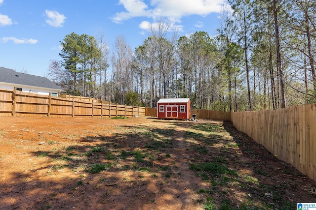 view of yard featuring a fenced backyard, a shed, and an outdoor structure