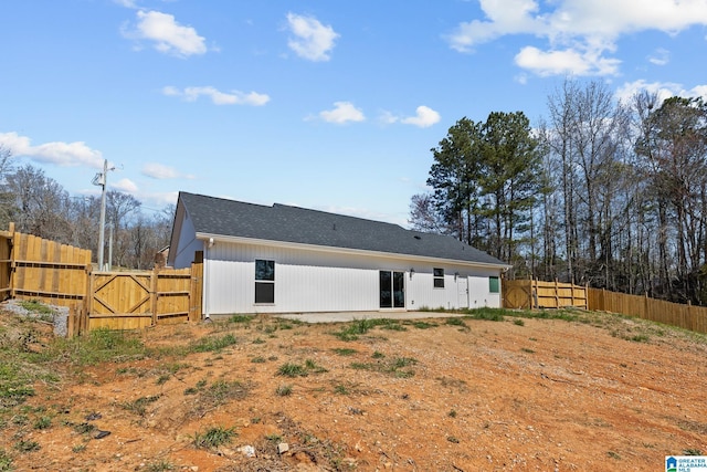 rear view of house with a gate and fence