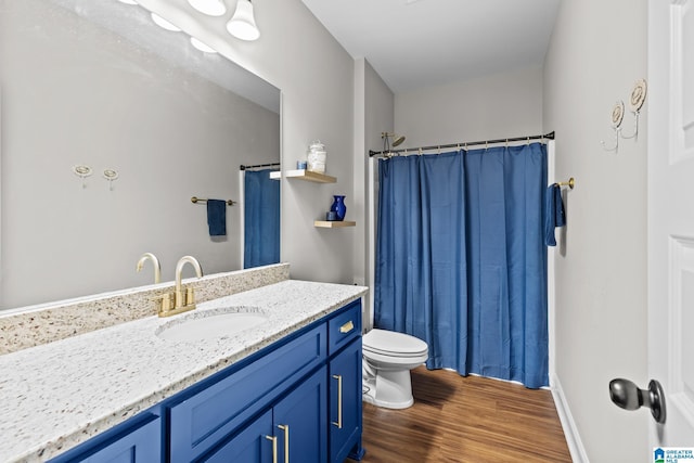 bathroom featuring vanity, curtained shower, toilet, and wood finished floors