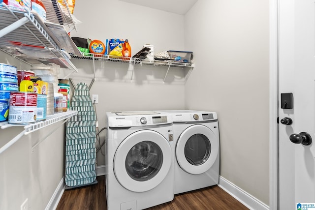 washroom featuring baseboards, separate washer and dryer, dark wood finished floors, and laundry area