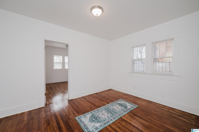 unfurnished room featuring wood finished floors and baseboards