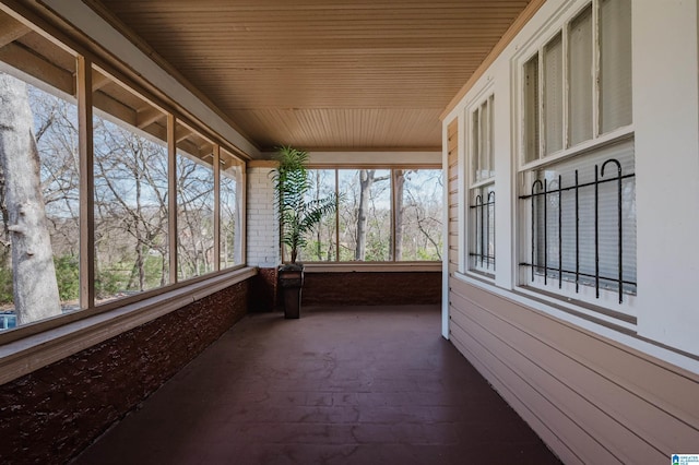 unfurnished sunroom featuring a wealth of natural light and wood ceiling