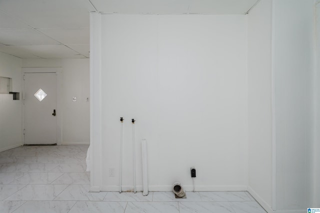 laundry area with marble finish floor, laundry area, and baseboards