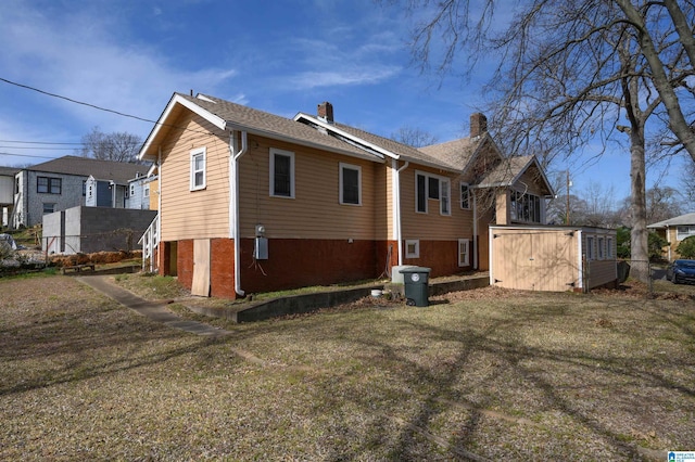 rear view of house with a yard