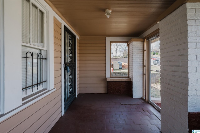 unfurnished sunroom with wood ceiling