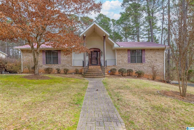 view of front of home with brick siding and a front yard