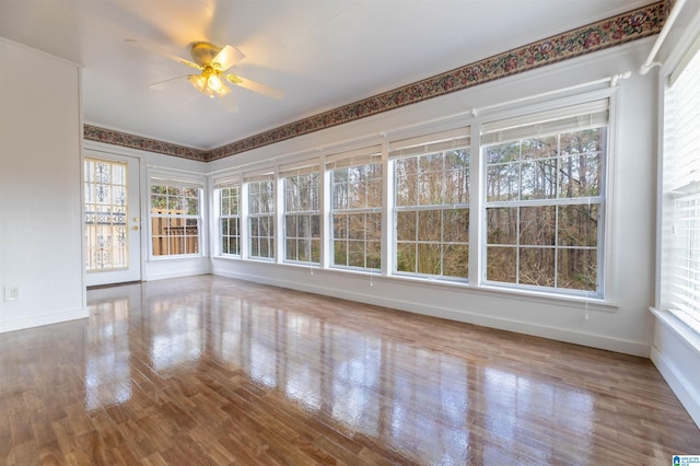 unfurnished sunroom with a ceiling fan