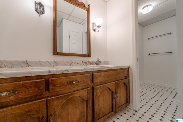 bathroom featuring vanity, baseboards, and tile patterned floors