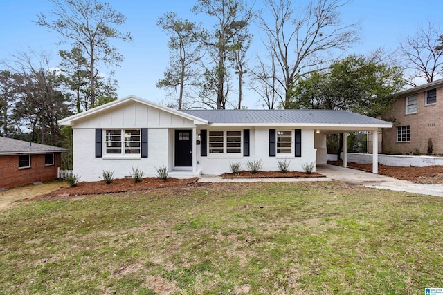 single story home featuring brick siding, concrete driveway, a carport, a front lawn, and board and batten siding