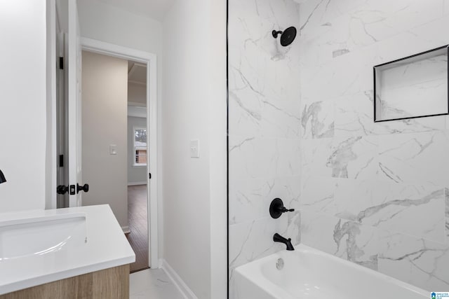 full bath featuring marble finish floor, tub / shower combination, vanity, and baseboards