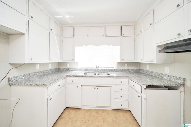 kitchen with white cabinets, a sink, and under cabinet range hood