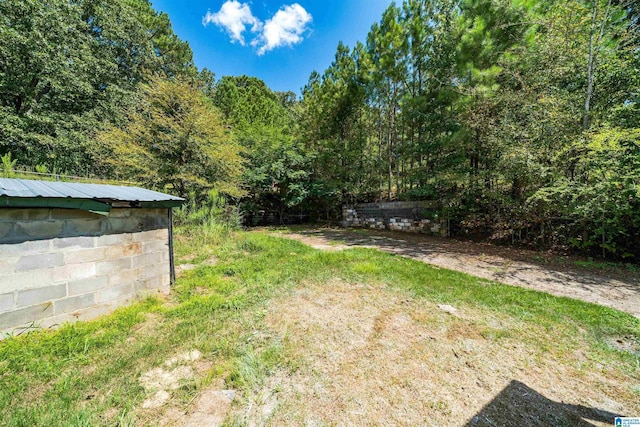 view of yard featuring a forest view