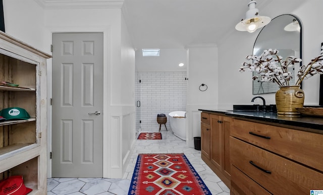 bathroom with a soaking tub, vanity, and crown molding