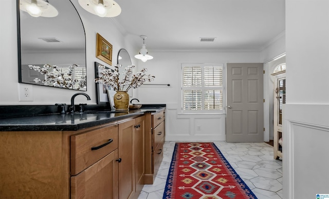 bathroom with visible vents, vanity, and crown molding