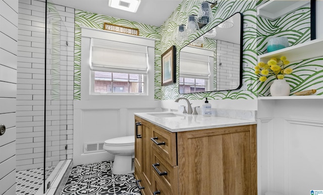 bathroom featuring tile patterned flooring, visible vents, toilet, a stall shower, and vanity