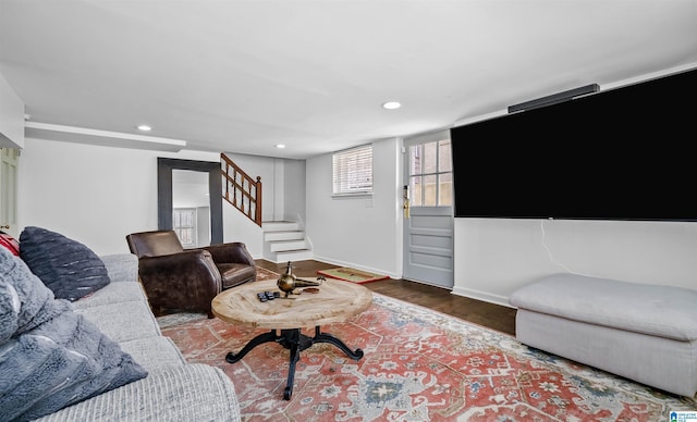 living room with stairs, recessed lighting, wood finished floors, and baseboards