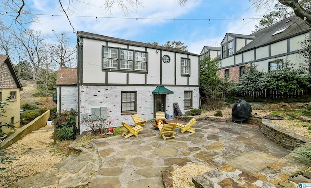 back of house featuring stucco siding, fence, and a patio area