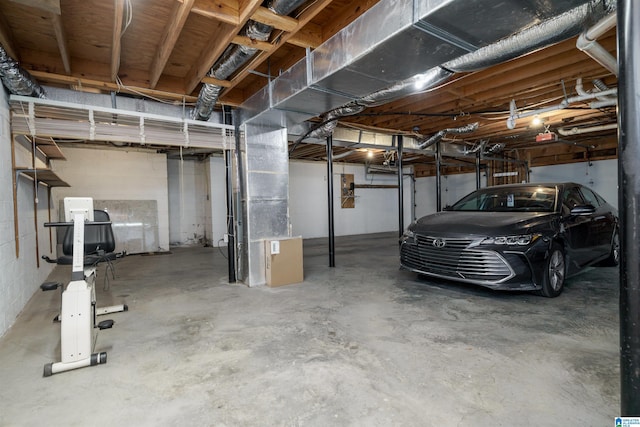 unfinished basement featuring heating unit