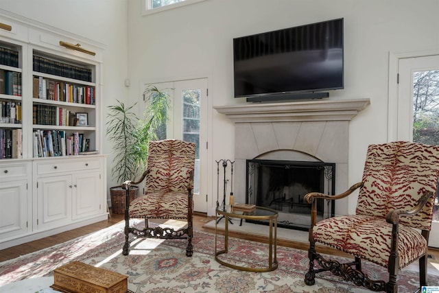 sitting room featuring a fireplace and wood finished floors