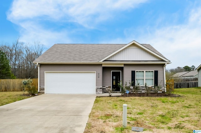 view of front of house with a garage, fence, driveway, roof with shingles, and a front yard