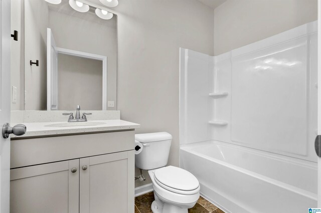 bathroom with baseboards, tub / shower combination, vanity, and toilet