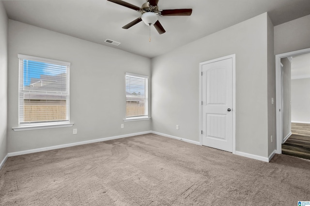 unfurnished bedroom featuring a ceiling fan, baseboards, visible vents, and carpet flooring