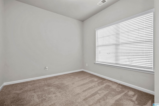 unfurnished room with baseboards, visible vents, and carpet flooring